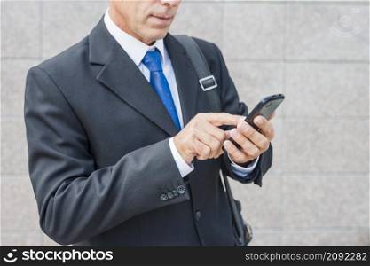 close up businessman s hand using mobile phone