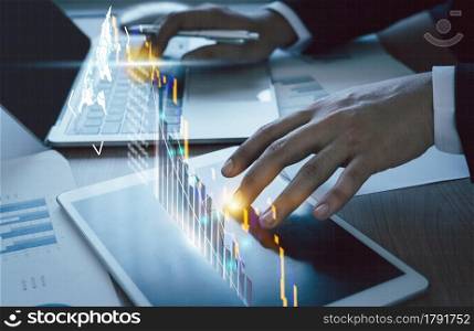 Close up Businessman working on table office deck for business growth up or stock market with data statistics level up of graph or chart.Financial and Technology concept ,planning and strategy icon.