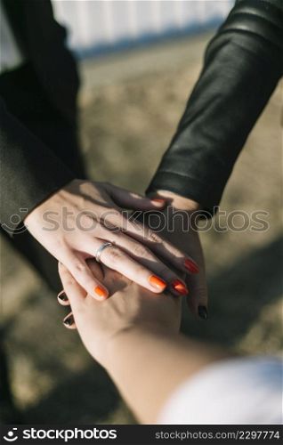 close up businesspeople stacking their hands outdoors