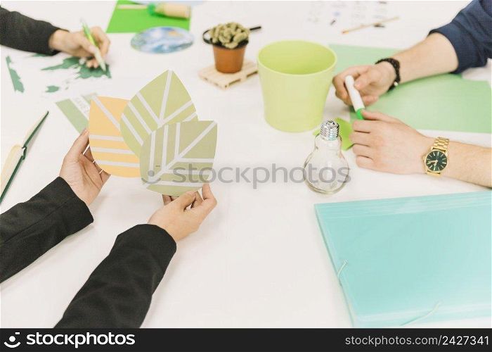 close up businessperson s hand holding eco icon