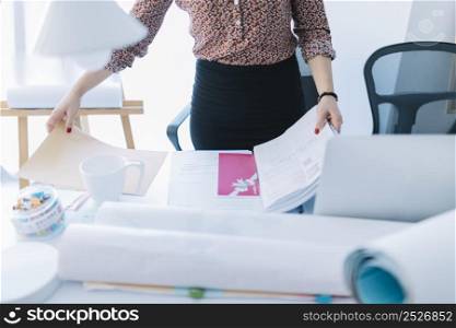 close up businesswoman holding opened file desk