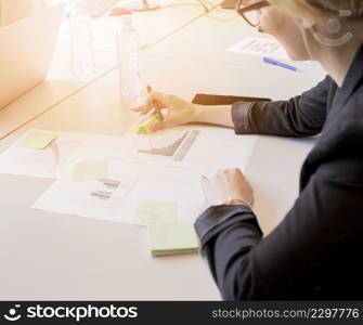 close up businesswoman looking sticky notes graph