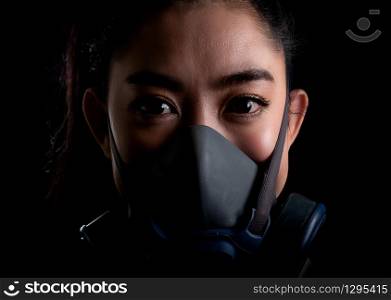 Close up businesswoman of young Asia woman putting on a respirator N95 mask to protect from airborne respiratory diseases as the flu covid-19 coronavirus PM2.5 dust and smog