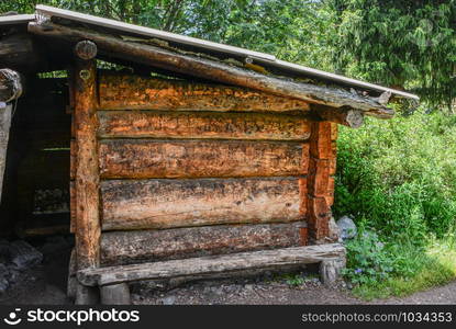 Close up cabine in the forest. Old wood shelter from rain.