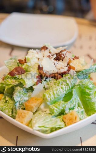 close up caesar salad on white plate , fresh and delicious