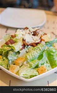 close up caesar salad on white plate , fresh and delicious