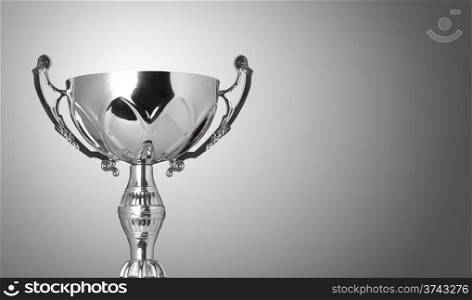 close up champion silver trophy on grey background