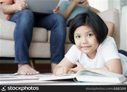Close up child cheerful playing on carpet in living room . Family are father mother and daughter happy together in home.