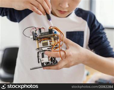 close up child making robots