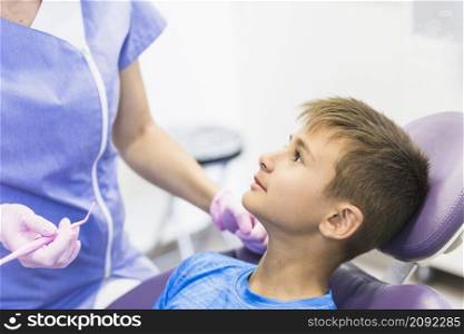 close up child patient leaning dental chair clinic