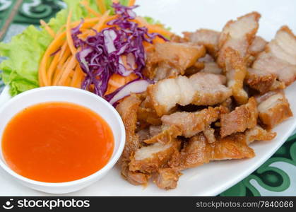 close up chili sauce and fried pork served with fresh vegetable