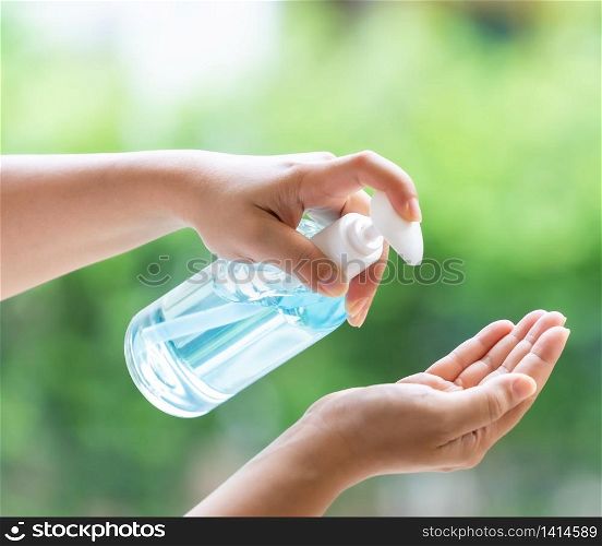 close-up cleaning hand using alocohol gel hand sanitizer waterless in pump bottle, disinfection for safety prevent and protect from infection of virus and germ Covid-19 coronavirus world pandemic.