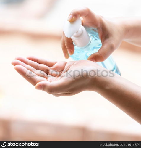 close-up cleaning hand using alocohol gel hand sanitizer waterless in pump bottle, disinfection for safety prevent and protect from infection of virus and germ Covid-19 coronavirus world pandemic.