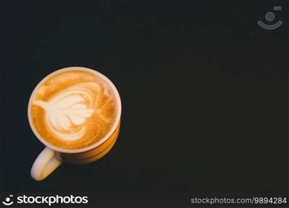 Close-up coffee latte art in cup and milk froth above to drink on back background 