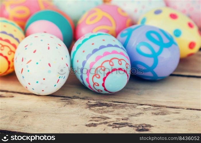 close up colorful easter egg on wood table background.