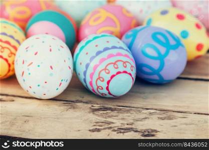 close up colorful easter egg on wood table background.