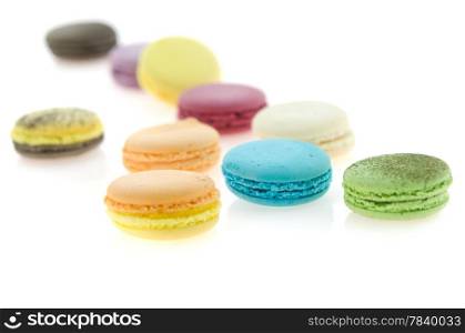 close up colorful french macaroons on white background