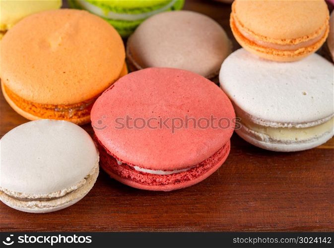 Close up colorful French or Italian macaron on wood table