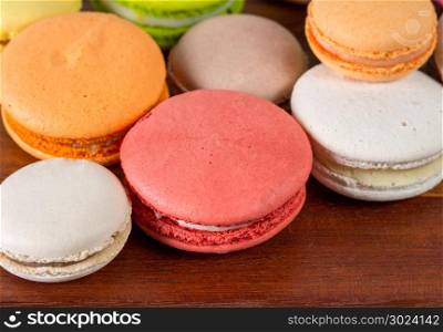 Close up colorful French or Italian macaron on wood table