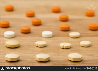 Close up colorful medical pills on wooden background. Close up medical pills on wooden table background