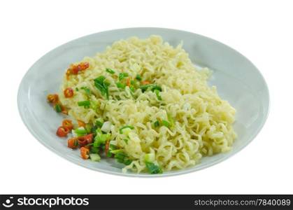 close up cooked instant noodles with chili and vegetable on dish over white background
