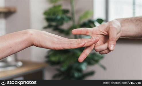 close up couple playing rock paper scissors game