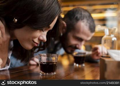 close up couple smelling cups coffee