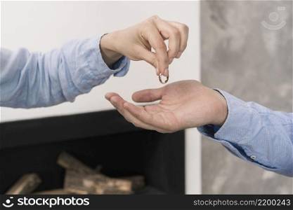 close up couple taking wedding rings off