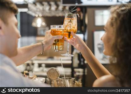 close up couple toasting drinks