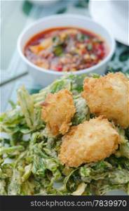 close up crispy shrimp and crispy vegetable served with red chili sauce , asian style cuisine