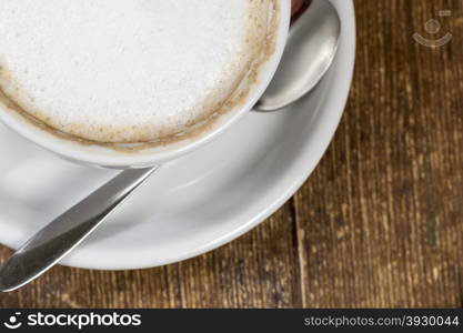 Close up cup of coffee on the wooden table. Cup of coffee on the vintage wooden table