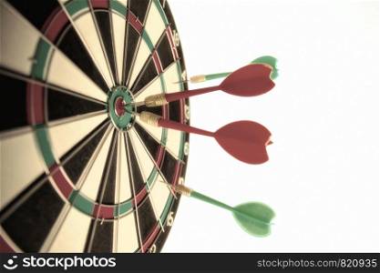 Close-up dart board with a red arrows that hit the center of the target. Darts Board Game