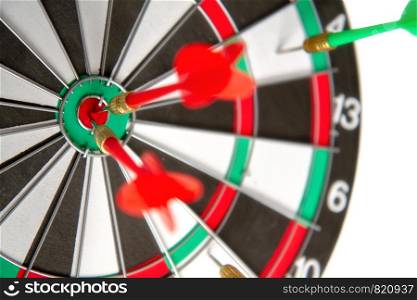 Close-up dart board with a red arrows that hit the center of the target. Darts Board Game