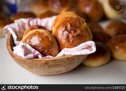 Close up detail of freshly baked hot cross buns in romantic renaissance lighting and a shallow depth of field.