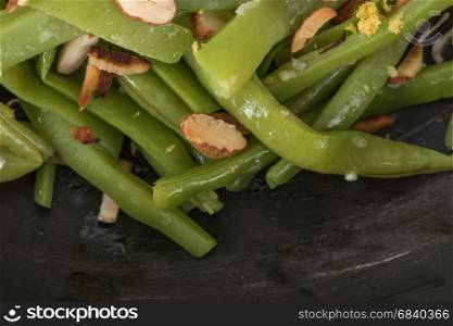 Close up detail of green beans with roasted almonds.
