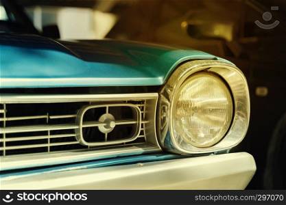 Close-up detail of retro car. Selective focus on the car's headlight.