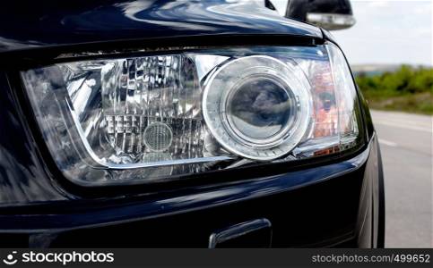 Close up detail on one of headlights modern car