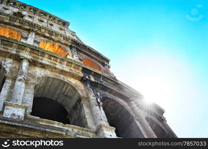 Close-up details of Colosseum with sunbeams. Rome, Italy