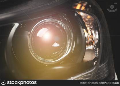 Close up details of projector lens headlights technology in a car.