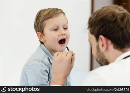 close up doctor checking kid s mouth