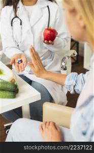 close up doctor comparing fruits pills