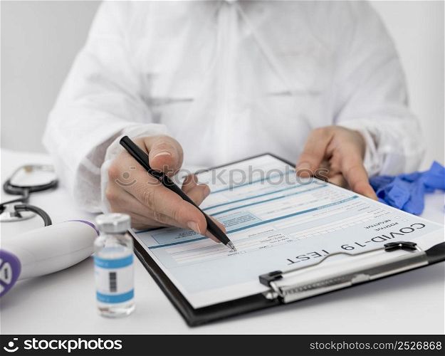 close up doctor completing covid medical form