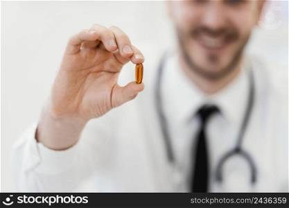 close up doctor holding pill