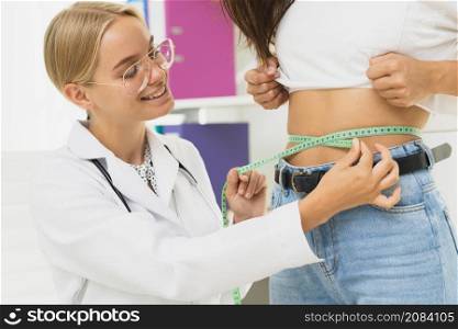 close up doctor measuring patient s abdomen