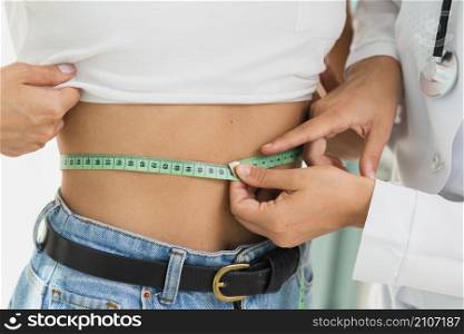 close up doctor measuring woman s abdomen