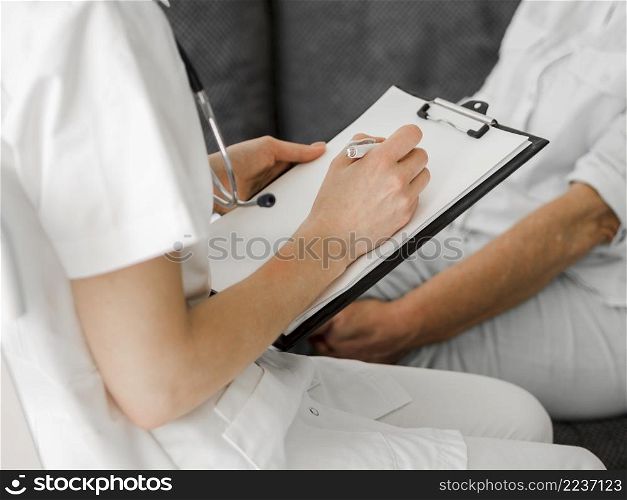 close up doctor taking notes