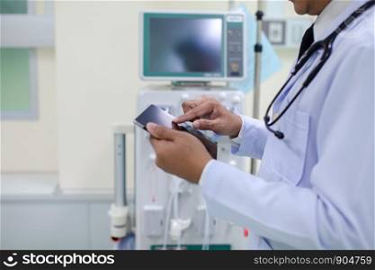 Close up doctor with stethoscope using tablet and blurred hospital area background, technology and medical health care concept.