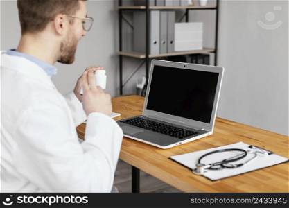 close up doctor working with laptop