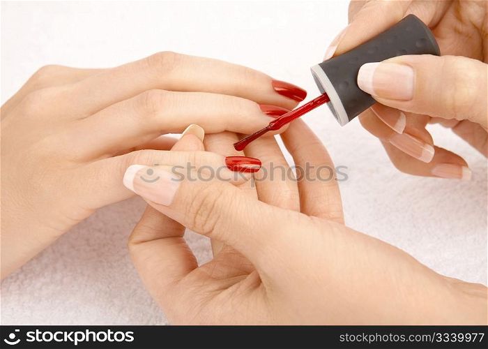 Close up - drawing of a red varnish on the nails, isolated