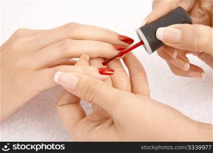 Close up - drawing of a red varnish on the nails, isolated